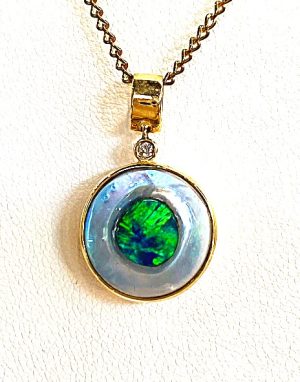 Opal Seeded In An Oyster Set In 14ct Gold With A Diamond