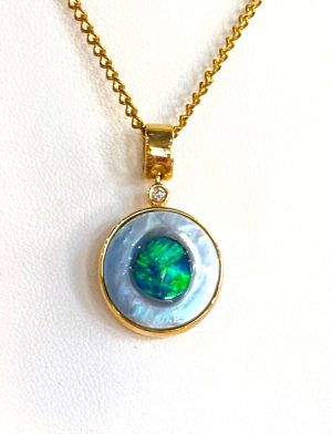 Opal Seeded In An Oyster Set In 14ct Gold With A Diamond